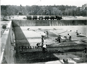 Placing the three layers of gravel and laying drain pipe 